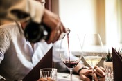 Crop-man-pouring-red-wine-in-glass-in-restaurant-37566231_thumbnail